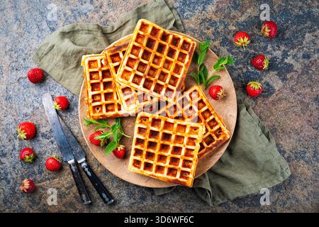 fresh baked homemade Brussels waffles with fresh strawberries on a plate Stock Photo