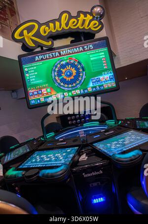 Electronic roulette station with digital screens, colorful betting data, hot and cold numbers, and illuminated casino gaming interface. Stock Photo