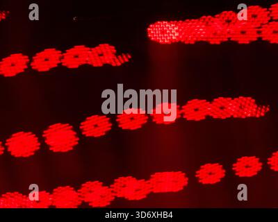 Glowing red digital gear shapes forming a patterned light design with an abstract and futuristic feel, ideal for backgrounds depicting technology, dat Stock Photo