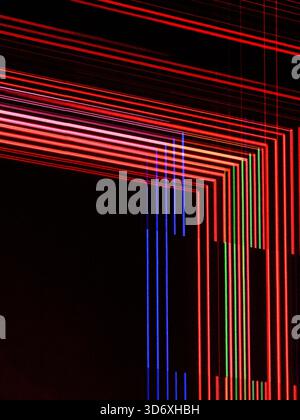 Abstract glowing red, blue, and green light trails forming a dynamic grid pattern on a dark background, representing digital data, modern technology, Stock Photo