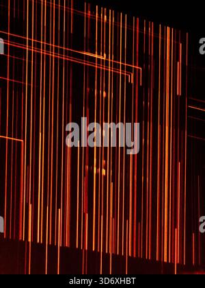 Glowing orange and red light lines creating a vibrant abstract grid pattern, representing futuristic technology, digital data, or energetic concepts a Stock Photo