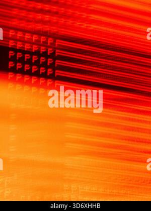 Abstract light painting creating a repeating pattern of the letter P with motion blur, forming a dynamic background of red and orange streaks represen Stock Photo