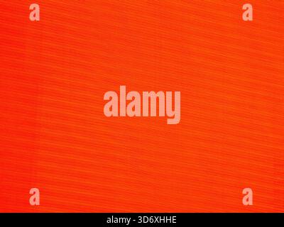 Vibrant red and orange abstract background with thin diagonal lines and textured stripes creating a dynamic, rhythmic patterned surface ideal for mode Stock Photo
