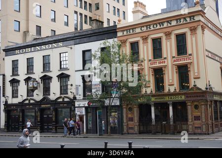 A  view of Great Victoria Street in Belfast, featuring the iconic Victorian facades of Robinson's Bar (1895) and The Liquor Saloon (1840). Stock Photo