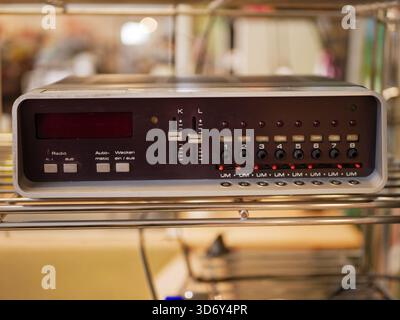 A retro electronic control panel with multiple switches, buttons, and indicator lights. This vintage equipment represents older industrial technology Stock Photo