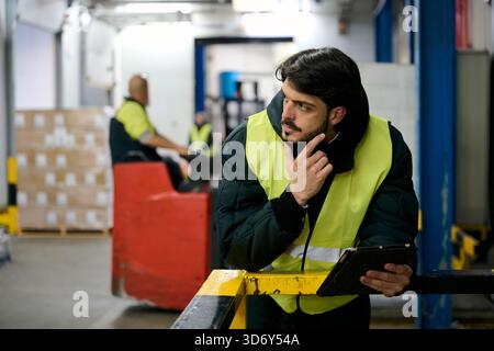 Logistics manager thinking about inventory control in cold chain warehouse Stock Photo
