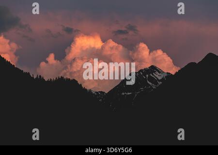 Dramatic sunset with colorful clouds over the mountains in Livigno, Italian Alps. Stock Photo