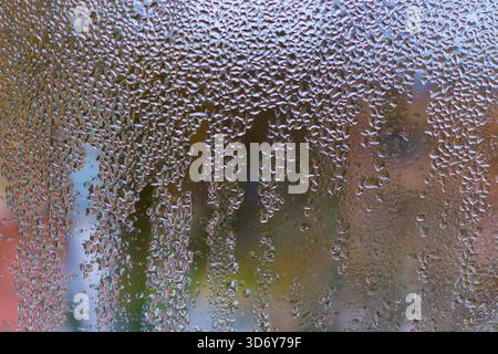 background of wet glass. water droplets on glass surface create beautiful abstract pattern. background for design and creatives. Water drops on glass Stock Photo