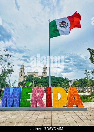 Merida Sign, Mexican flag, Plaza Grande, Cathedral de IIdefonso in the ...