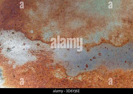 The abstract patterns of rust and corrosion on the side of an antique car Stock Photo