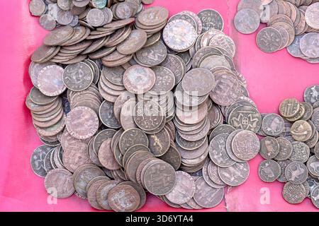 Old, vintage indian coins background in Indian market on the street in Rishikesh, India. Close up. Stock Photo