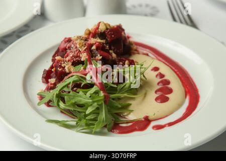 Beetroot salad served with hummus and fresh arugula Stock Photo
