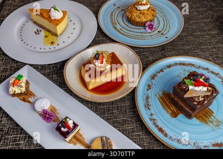 Assorted gourmet desserts including flan cakes and pastries, elegant restaurant presentation for hotel and fine dining menus. Stock Photo