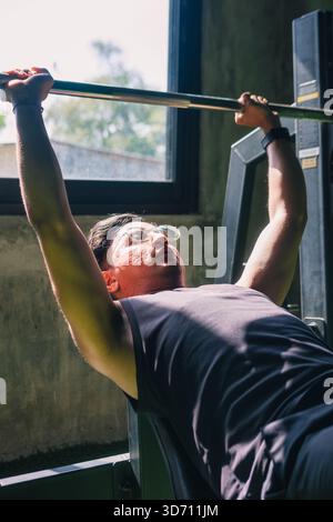 A man is doing gym exercise at a gym club in the Jimbaran area, September 14, 2025, Bali, Indonesia Stock Photo