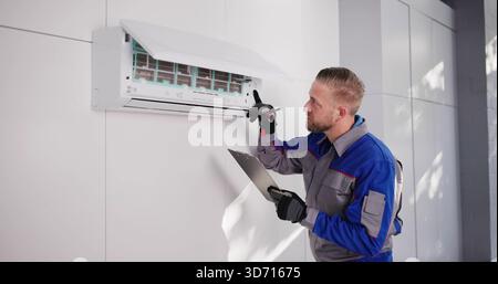 Professional HVAC Technician Installing Air Conditioner On Rooftop, Checking Efficiency. Stock Photo