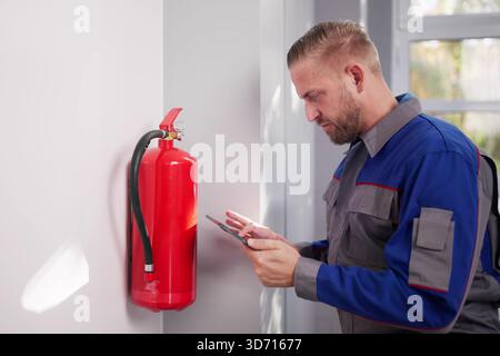 Ensuring Security By Installing Emergency Fire Extinguisher In Antique Store Stock Photo