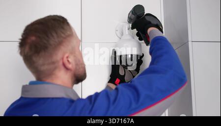 Professional Technician Installs CCTV Camera For Security Surveillance Video Service. Stock Photo