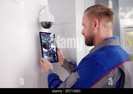 Tech Expert Enhances Office Security With Video Surveillance Installation Service. Stock Photo