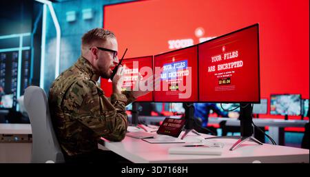 Government Soldier At Military Control Center Faces Ransomware Attack Stock Photo