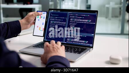 Working Professional Organizing Schedule On Laptop And Smartphone At Office. Stock Photo