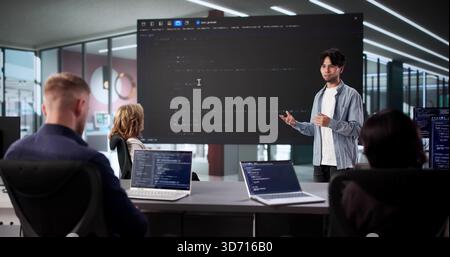 Web Software Developers Meet In Classroom For Late Night Meeting Stock Photo