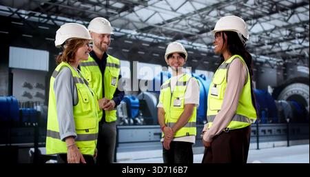 Workers Shaking Hands At Power Plant Facility, Sealing New Agreement. Entrepreneur Rewarded Diverse Team Stock Photo
