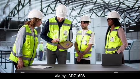 Teacher Explaining Wafer Handling In Chip Factory To Diverse Group. Stock Photo