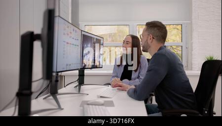 Two Graphic Designers Working On Computer For Print And Web. Stock Photo