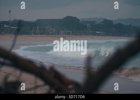 Large ocean waves hit Jimbaran beach in the morning Stock Photo