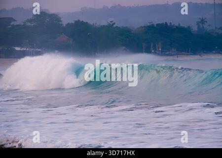 Large ocean waves hit Jimbaran beach in the morning Stock Photo