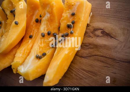Pieces of Papaya. Fresh and healthy papaya fruit slices with seeds. Carica papaya. Stock Photo