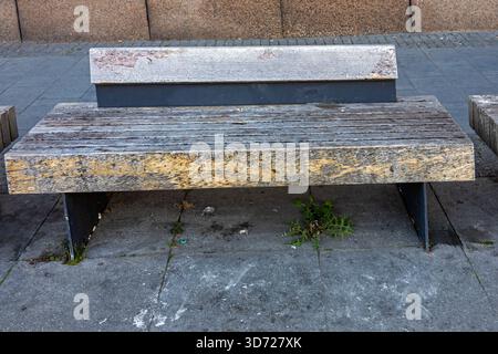 Empty bench with wooden flat seat surface outside on a street Stock Photo