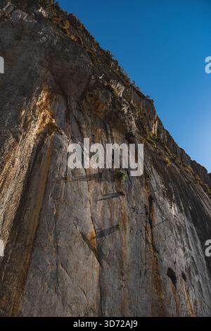 vertical wall photographed from the bottom of a rock cliff Stock Photo