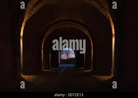 Landscape seen thru old gate archway in sundown. The picturesque medieval old town city gate from inside Stock Photo