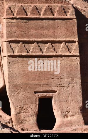 Unique rock cut structure features distinct patterns, carved in sandstone. The entrance reflects ancient craftsmanship, showcasing the heritage of the Stock Photo