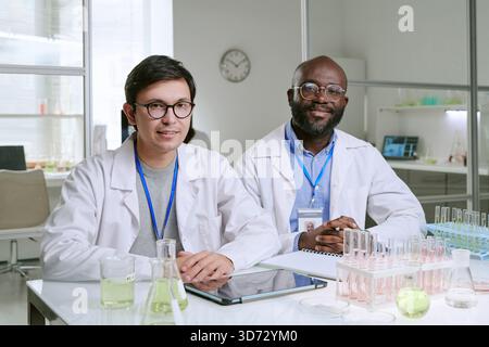 Caucasian Young Adult Man and Black Middle Aged Man Working in Laboratory Stock Photo