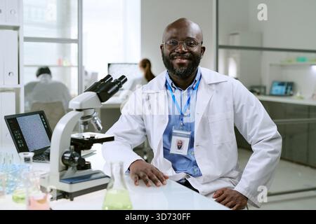 Portrait of Middle Aged Black Man Smiling While Working in Medical Laboratory Stock Photo