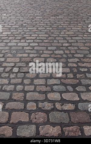 Close-up of setts pavement, which are quarried stones that are cut into a roughly rectangular or square shape, Pitkäsilta, Helsinki, Finland. Stock Photo