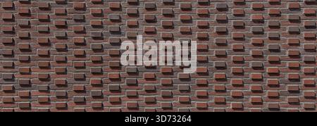 Close-up of red brick wall featuring a highly textured, three-dimensional pattern in summer, Konepaja, Helsinki, Finland. Stock Photo