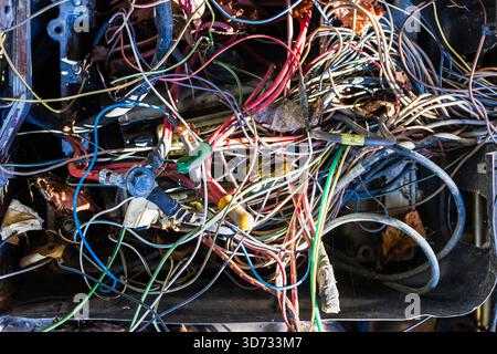tangled electrical wiring in old abandoned car outdoors on autumn day Stock Photo