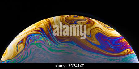 colorful semi-circular soap bubble on black background Stock Photo