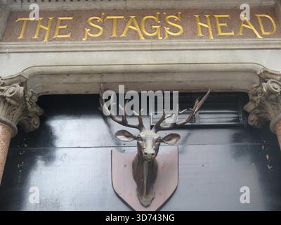 Dublin, Ireland - 07th May 2016 - Close up view of the top of the entrance to The Stag's Head pub, with ornate stag's head sculpture, in Dublin city centre Stock Photo