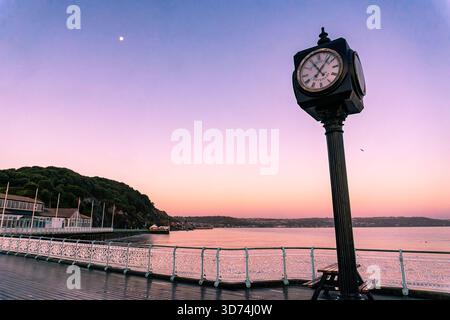 The Mumbles Pier Centenary Clock at dawn, on the Mumbles Esplanade in Swansea, Wales Stock Photo