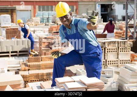Builder is choosing ceramic tiles in building store Stock Photo