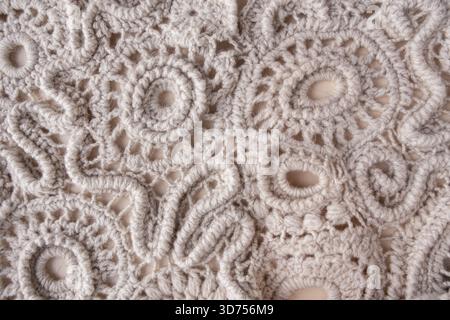 Hand-knitted lace made from wool threads, textured background Stock Photo