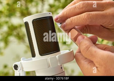 Close up of fingers pressing a single mechanical keyboard switch near a microphone. Recording clicking and tactile ASMR tech sounds. Stock Photo