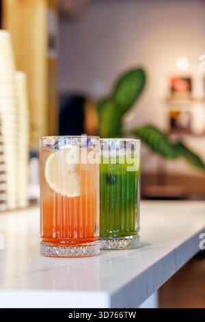 Assorted summer lemonades in glass jars with fresh fruits, ice, and colorful garnishes Stock Photo