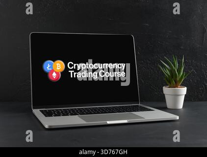 Cryptocurrency trading course advertisement displaying on laptop screen, promoting education in digital finance and investment strategies Stock Photo