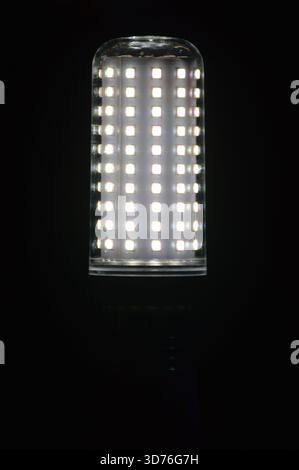 Glowing LED corn light bulb isolated on black background. Stock Photo