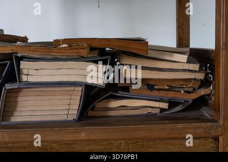 A closeup of ancient thread-bound books with Chinese characters ...